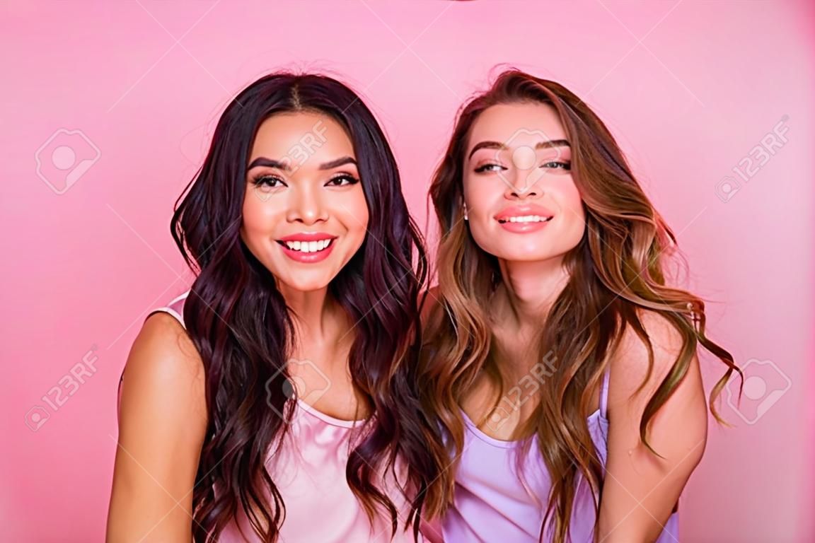 Close up photo of cute stunning pretty nice ladies millennial have free time weekend summer feel rejoice candid dressed fashionable clothes trendy stylish isolated pink background