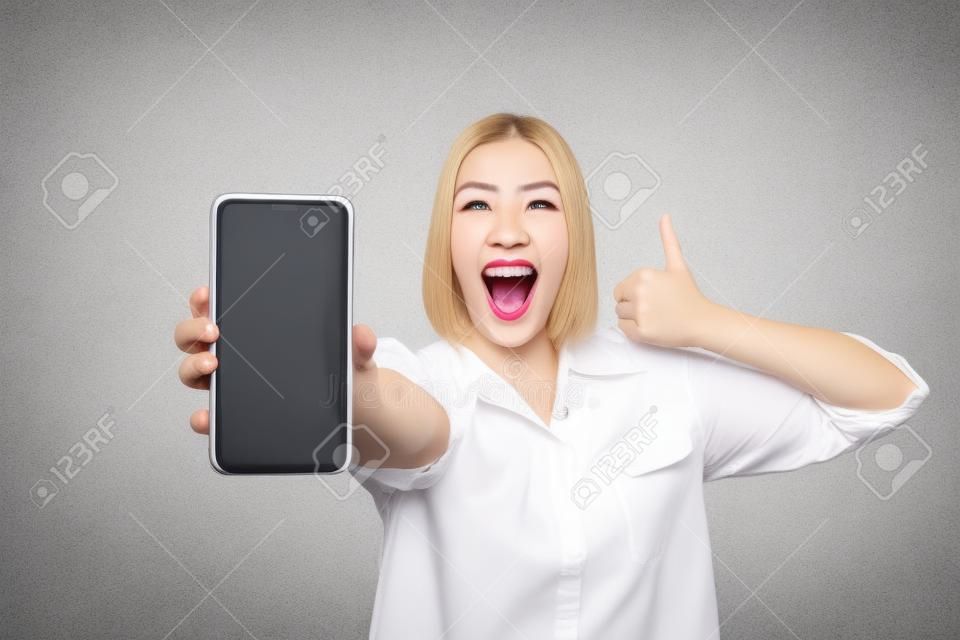 Close up photo crazy beautiful she her lady hands arms telephone raise thumb up yell scream shout advising customer buy buyer device low price wear casual white shirt isolated grey background