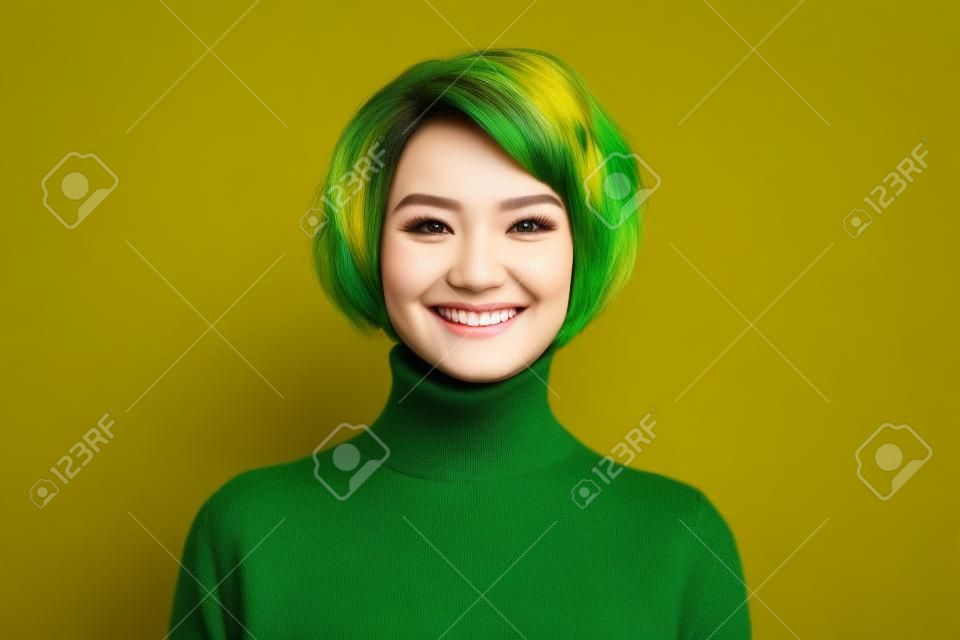 Primo piano di una divertente pettinatura corta signora affascinante sorridente buon umore persona positiva indossare casual dolcevita verde maglione caldo isolato colore giallo sfondo