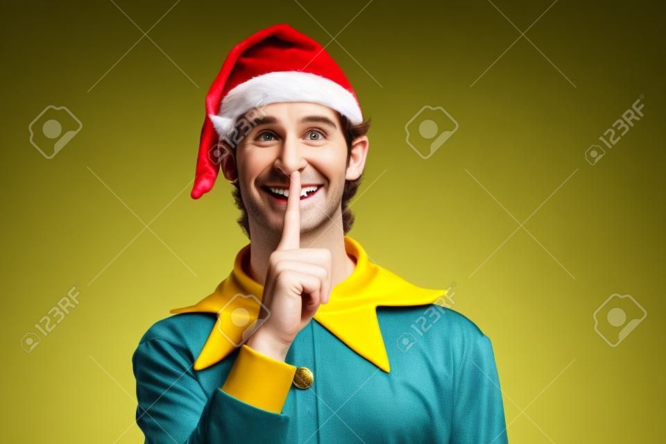 Zbliżenie portret jego miłego atrakcyjnego ciekawego wesołego zabawnego faceta elf pokazujący shh symbol eve noel wróżka patrząc na bok kopia przestrzeń odizolowana nad jasnym żywym połyskiem żywy żółty kolor tła