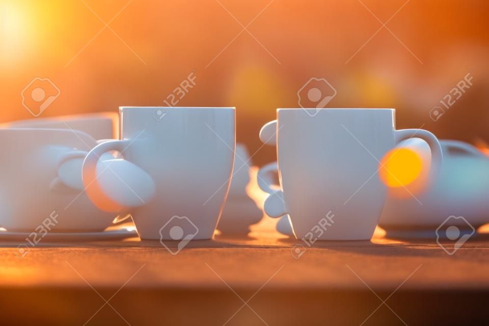 Paar mit zwei Tassen Morgenkaffee bei Sonnenaufgang