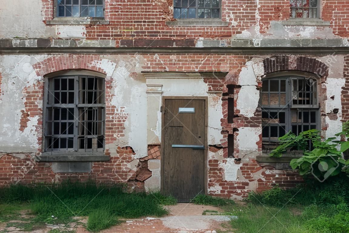 Old ruins of abandoned ruined red brick building, vintage toned