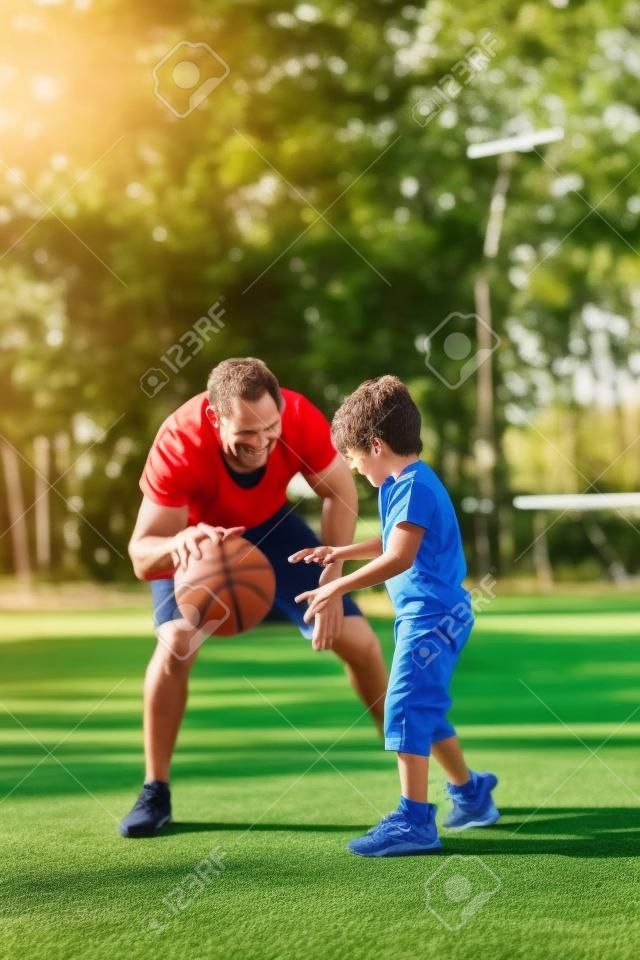 Father and son playing basketball outdoors