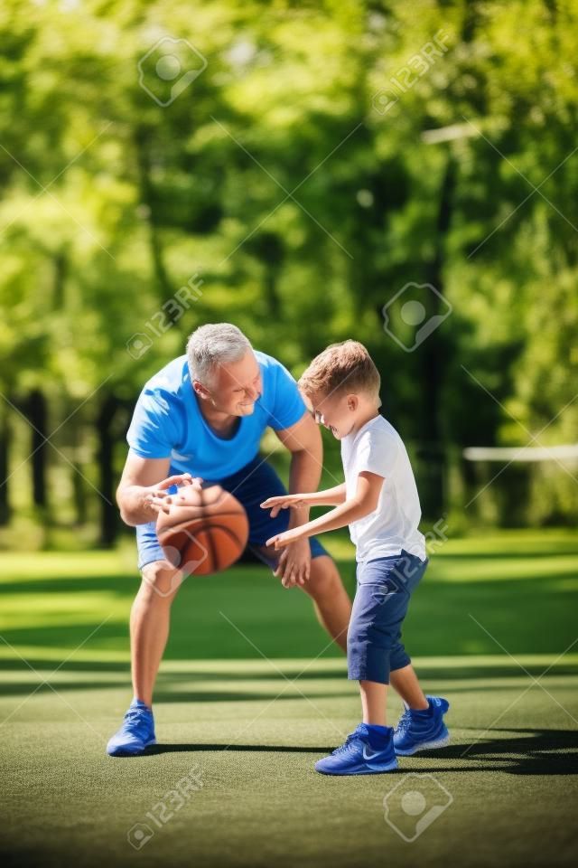 Father and son playing basketball outdoors