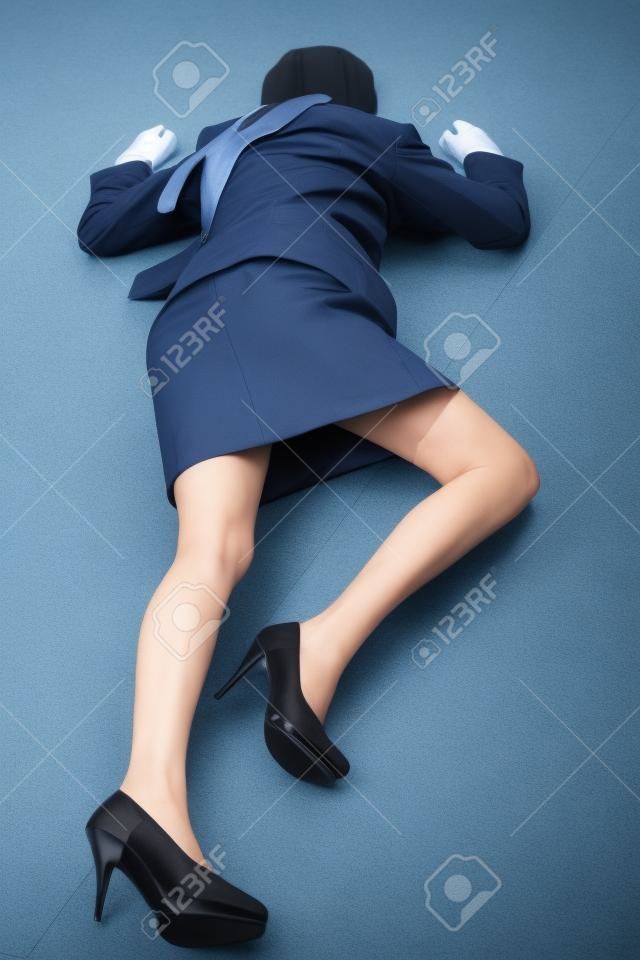 Crime scene imitation. Killed business woman lying on the floor