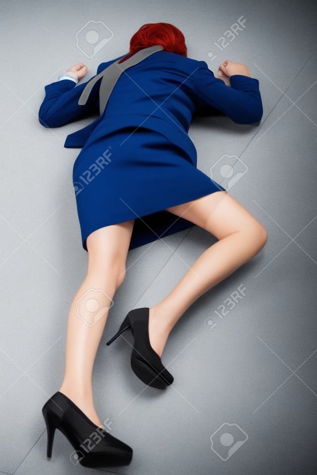 Crime scene imitation. Killed business woman lying on the floor