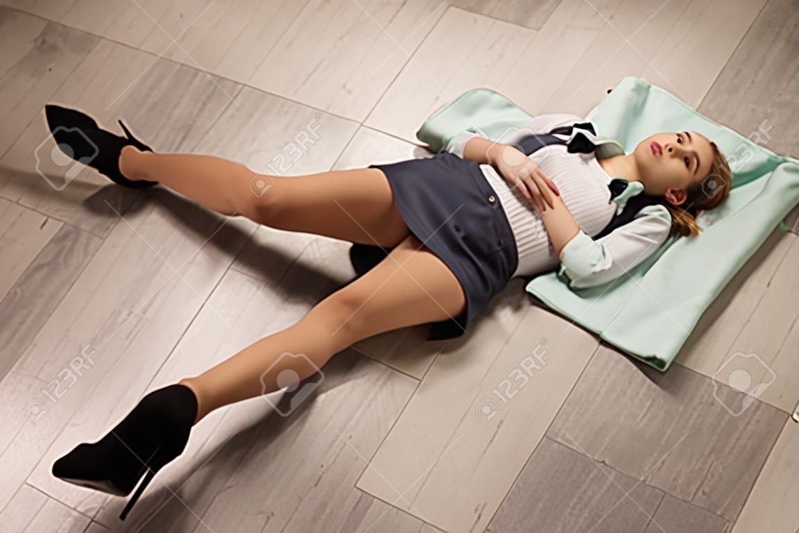 Crime scene simulation: college girl lying on the floor