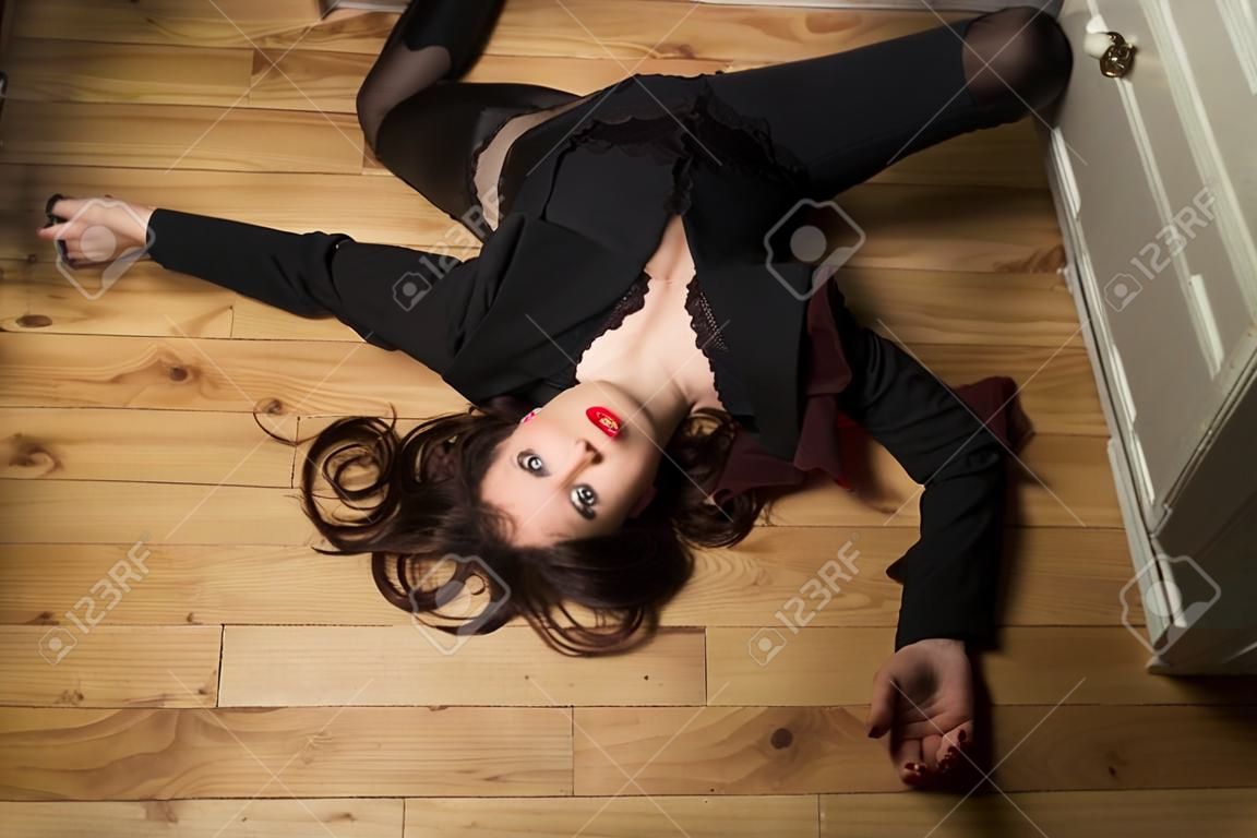 Crime scene. Dead business woman dressed black suit in the closet