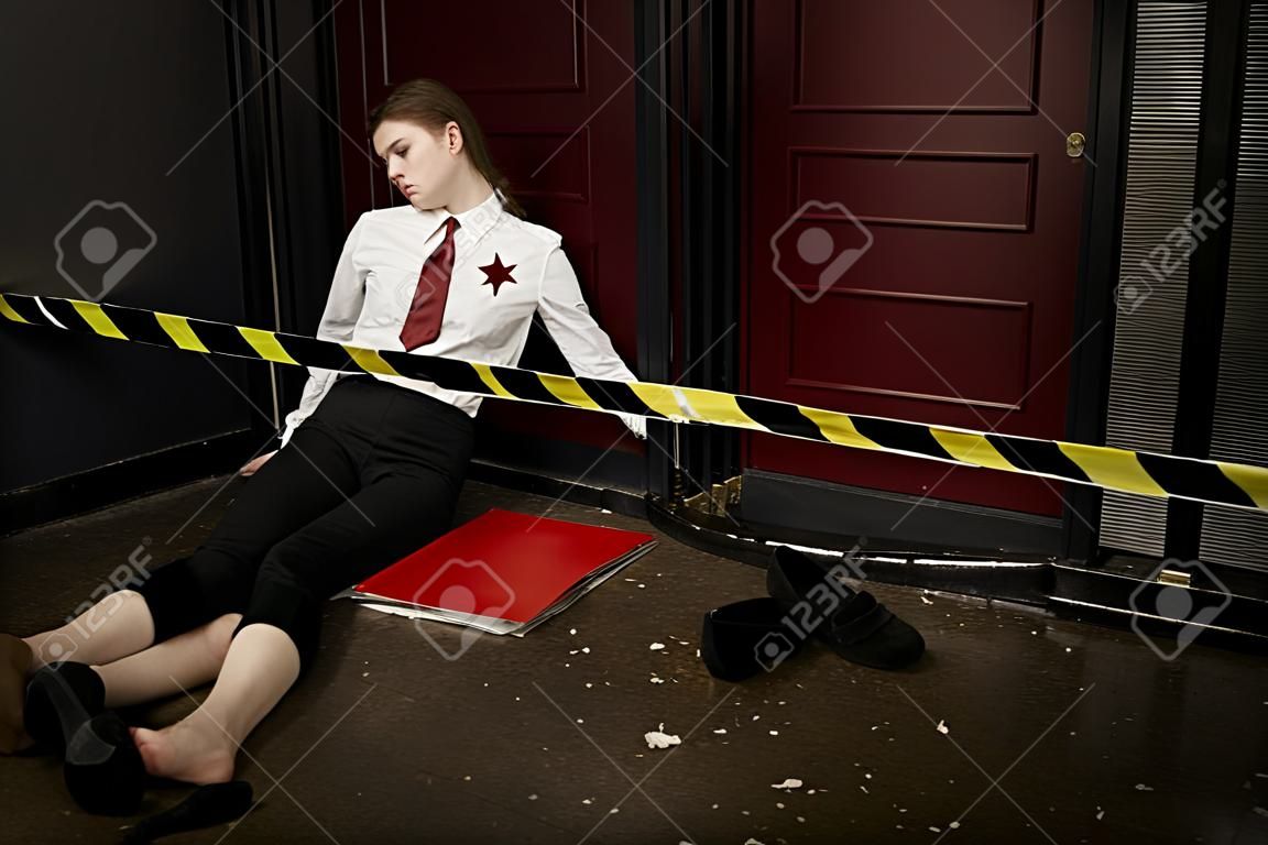 Crime scene. Business woman shot in the chest in old elevator
