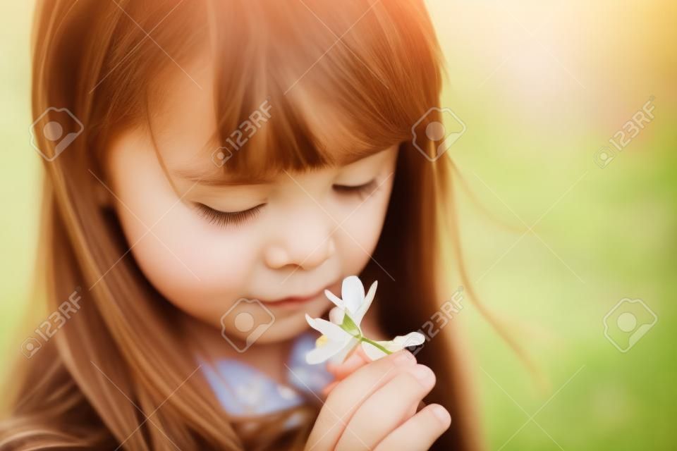 Portrait der schönen jungen Mädchen mit Blumen im Park