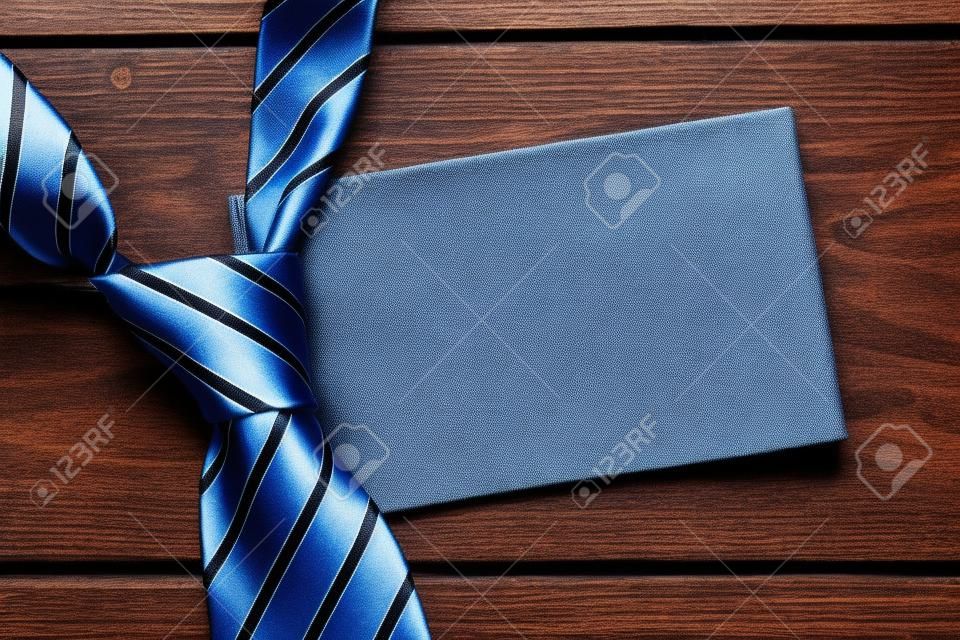 Father's Day Concept. Striped tie on wooden background with copy space