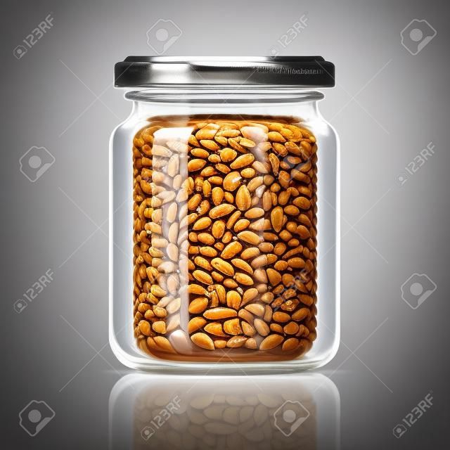 Transparent glass jar with peanut butter.