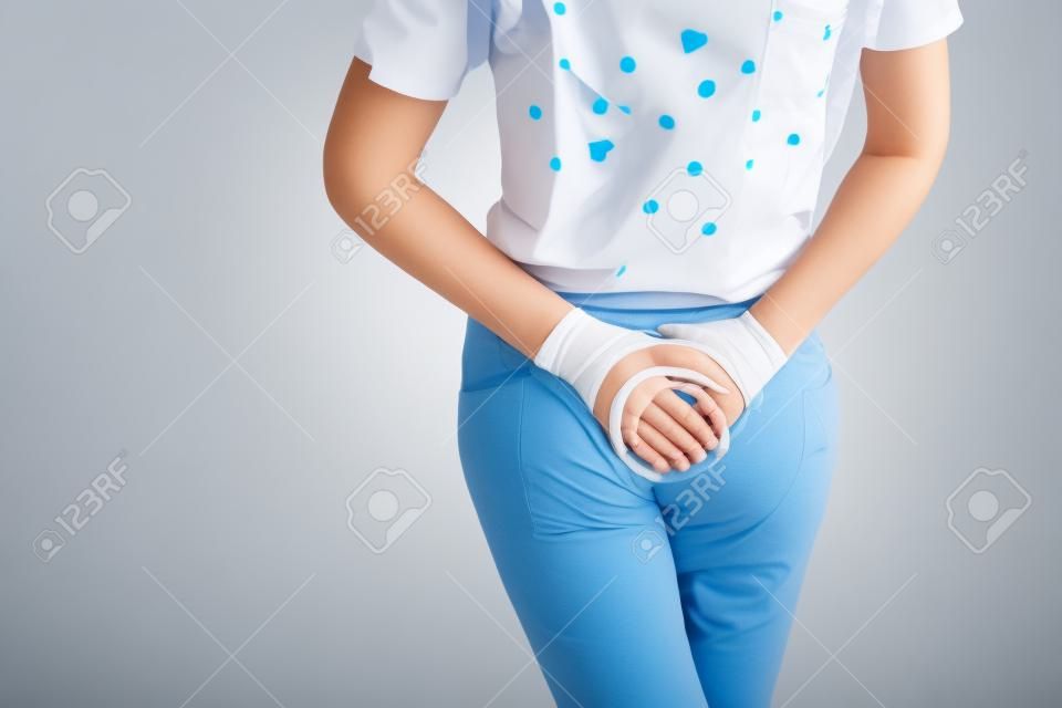 Young sick woman with hands holding pressing her crotch lower abdomen. Medical or gynecological problems, healthcare concept