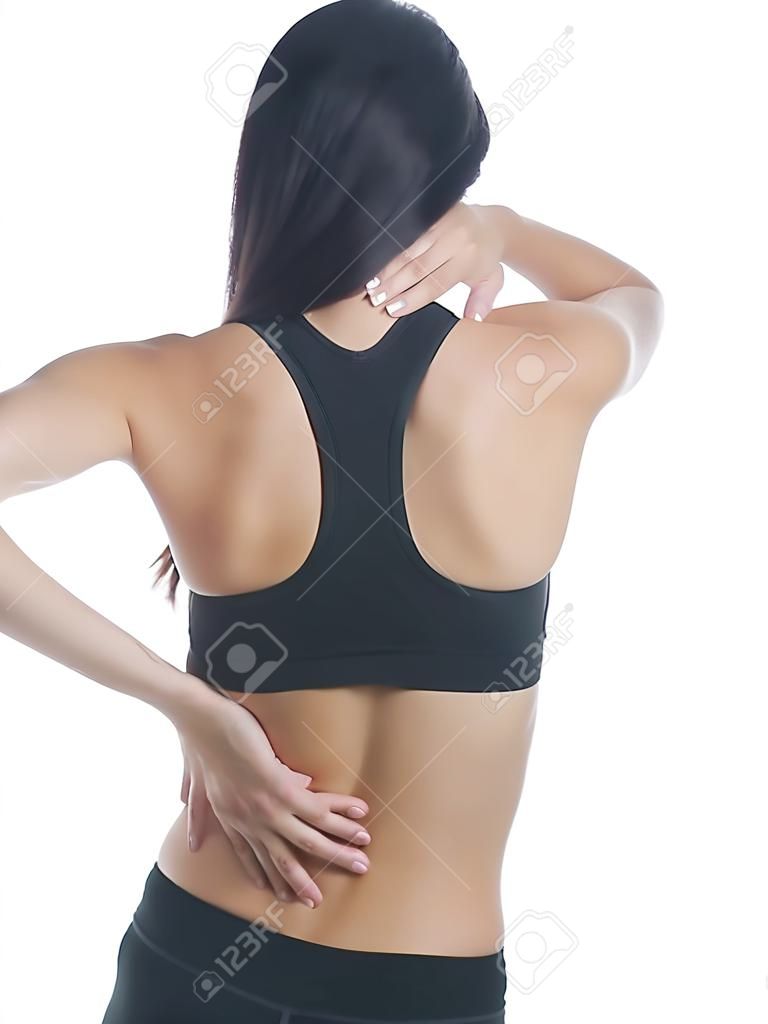 Isolated studio shot of a woman in a fitness outfit experiencing neck, shoulder  and back pain.