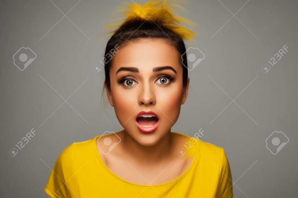Woman in a yellow t-shirt on  gray