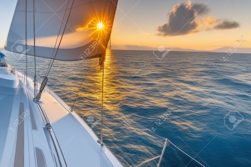 Luxury yachts. Yacht sailing towards the sunset.