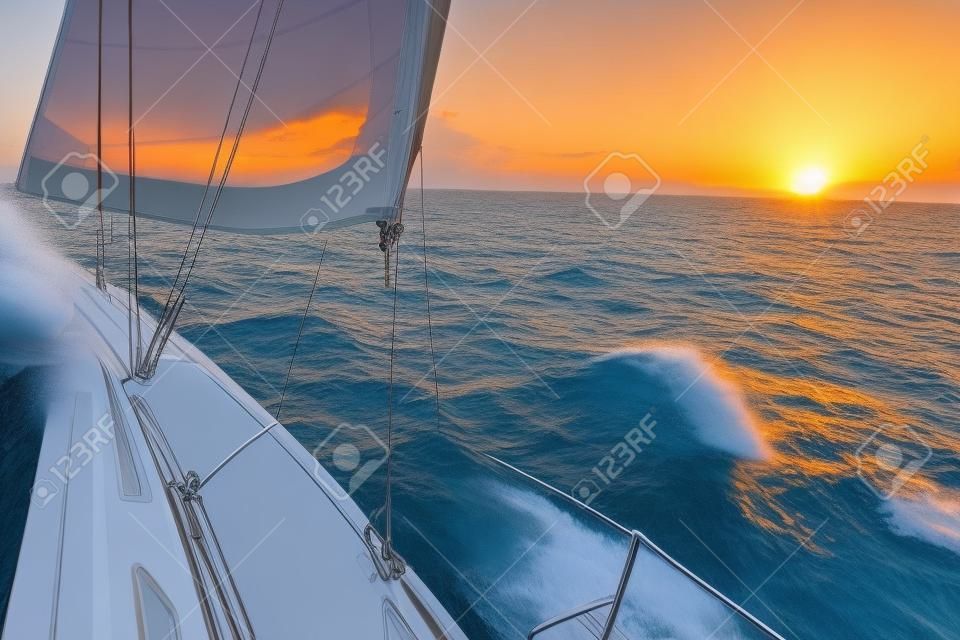 Luxury yachts. Yacht sailing towards the sunset.