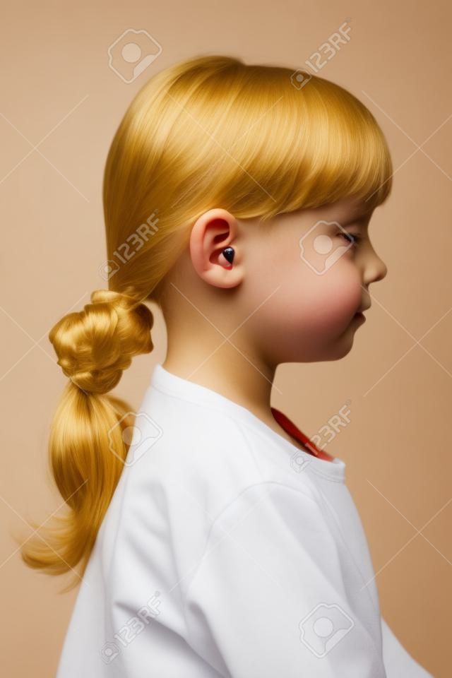 Little cute girl with ear plugs in his ears