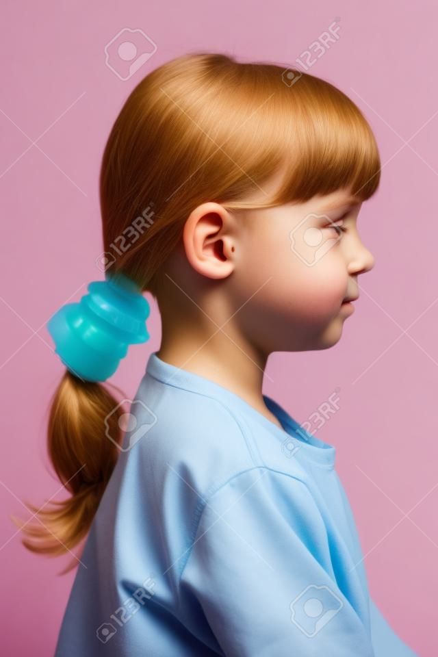 Little cute girl with ear plugs in his ears