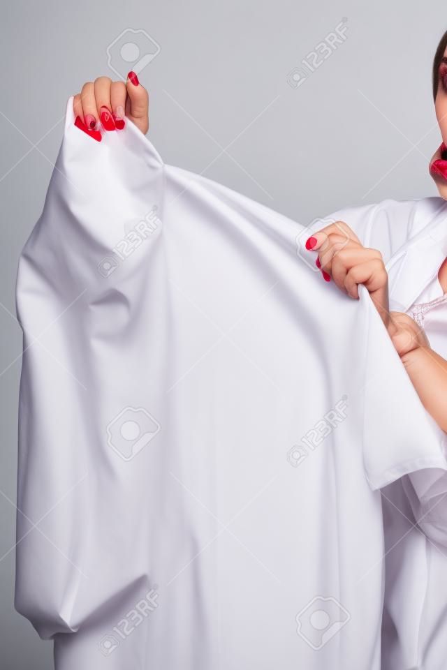 Woman Holding Shirt With Lipstick On White Background