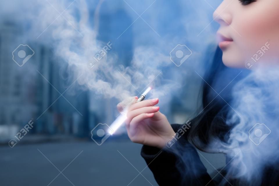 Girl smoking electronic cigarette.