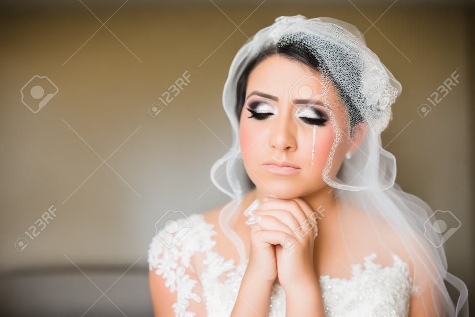 portrait of the bride crying, sadness, streaks mascara wipes. Natural light