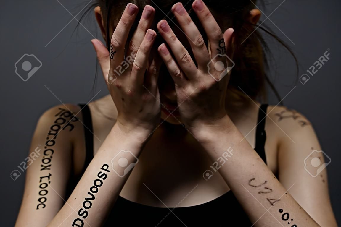 Woman with inscriptions on her body black little information discontent depression