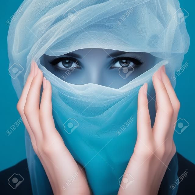 Woman with veil over white backgroung