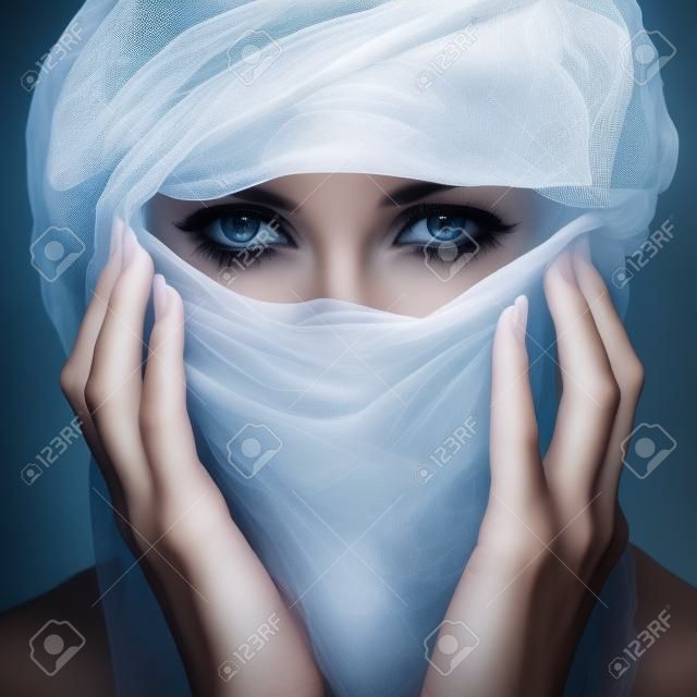 Woman with veil over white backgroung