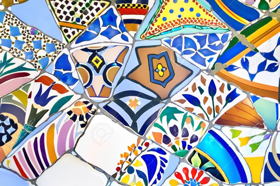 Famous colorful ceramic mosaics detail, designed by Antonio Gaudi and better known as  trencadis   Located in the park Guell of Barcelona, Spain
