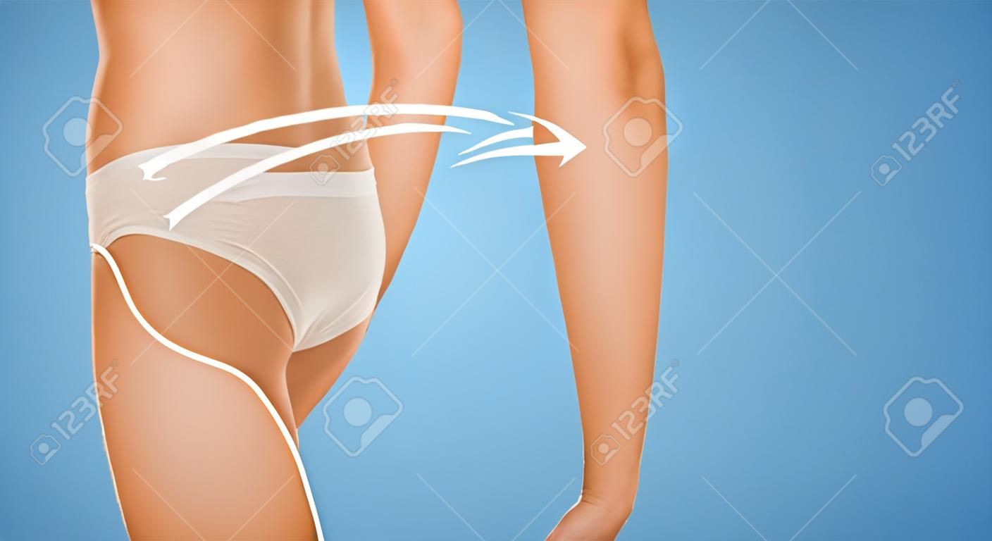 people, health, body care and beauty concept - close up of slim woman tummy and hips in underwear over blue background