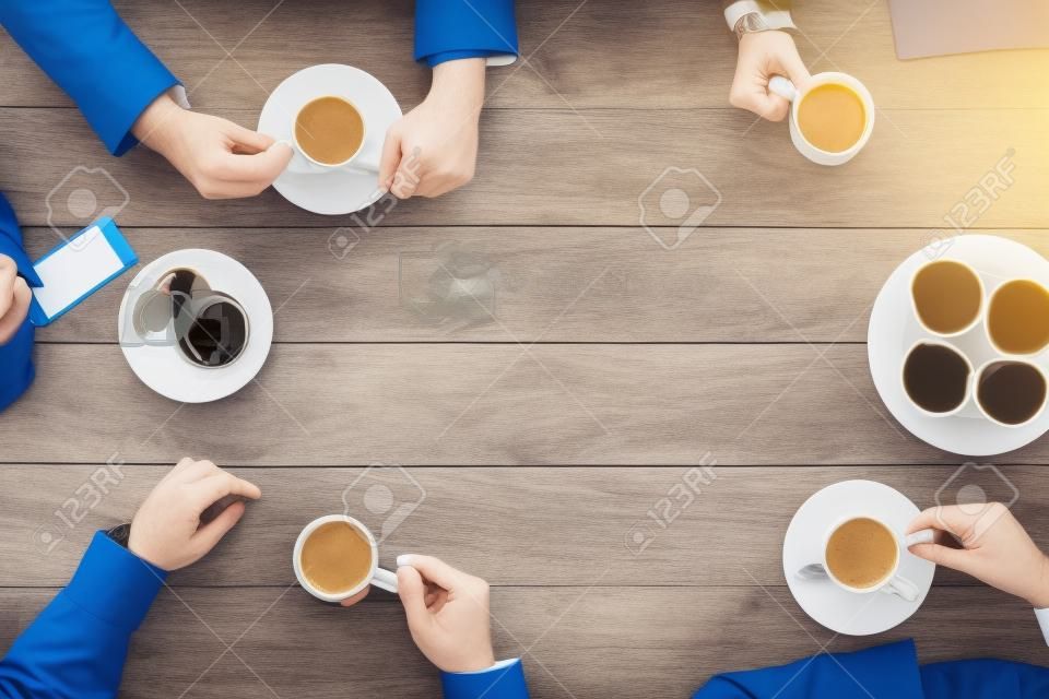 business, people and team work concept - close up of creative team meeting and drinking coffee during lunch in office