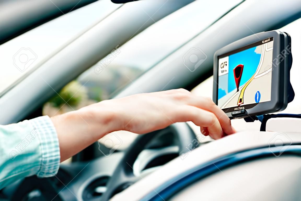 transport, business trip, technology, navigation and people concept - close up of male hand using gps navigator while driving car
