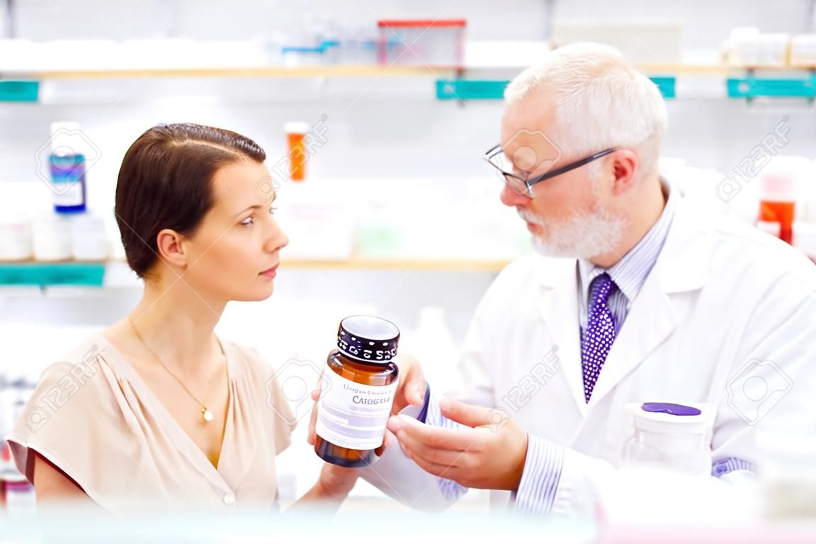 apothicaire et femme avec un médicament à la pharmacie