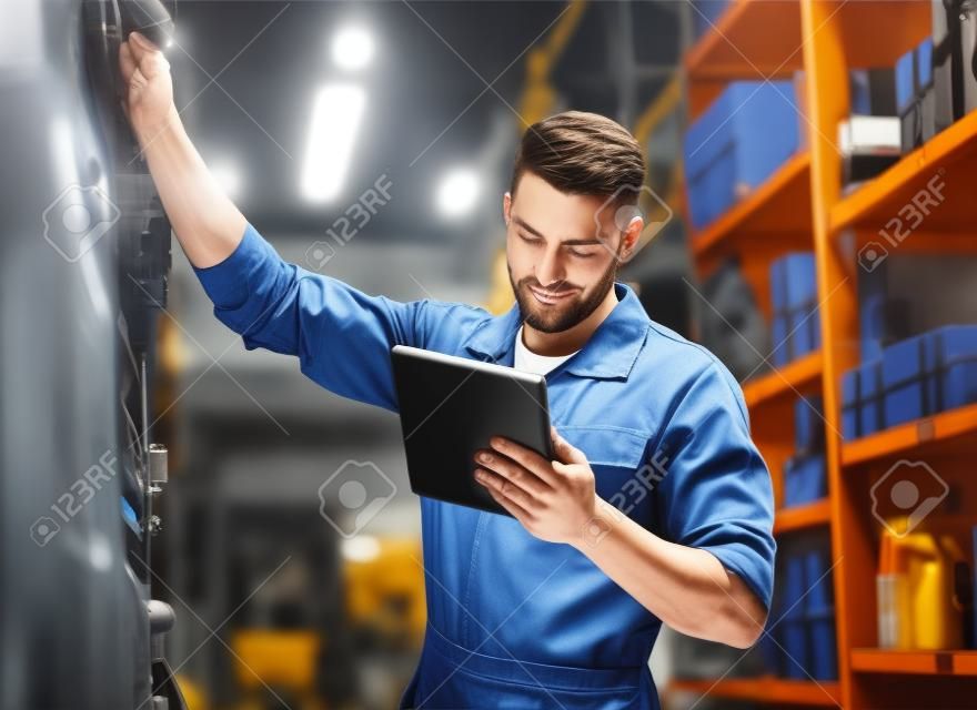 auto mechanic or smith with tablet pc at workshop