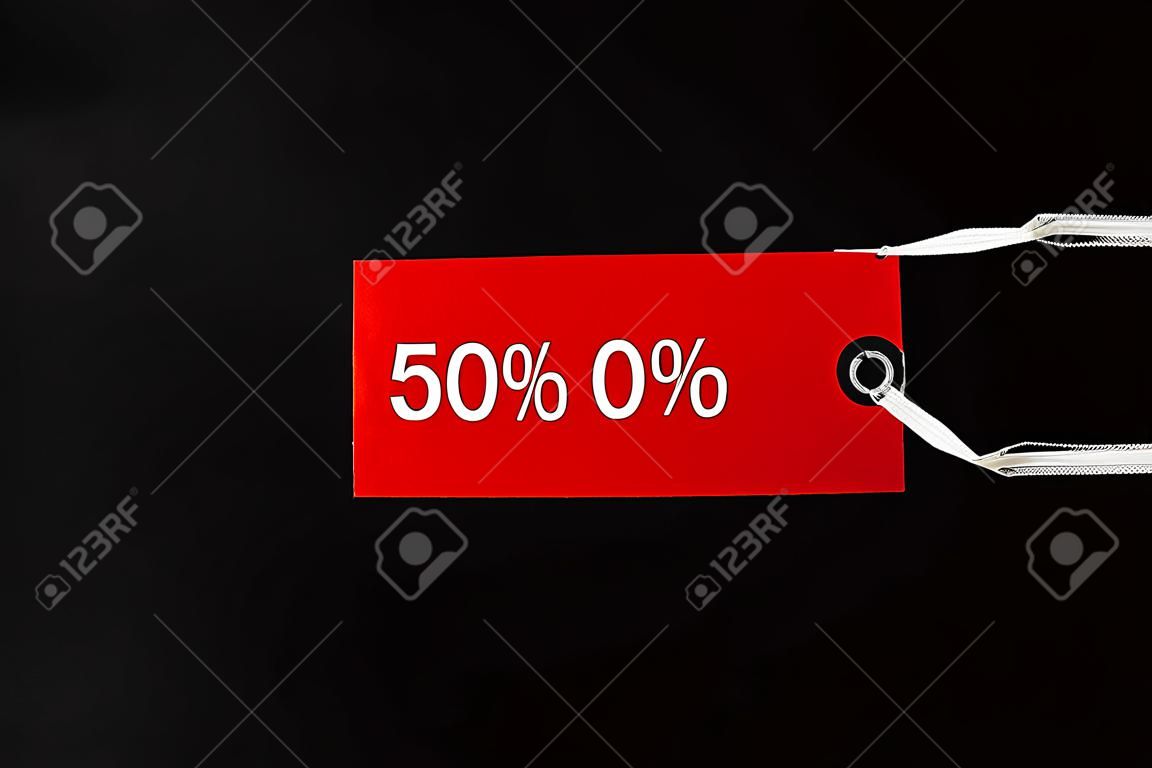 red tags with discount signs on black background