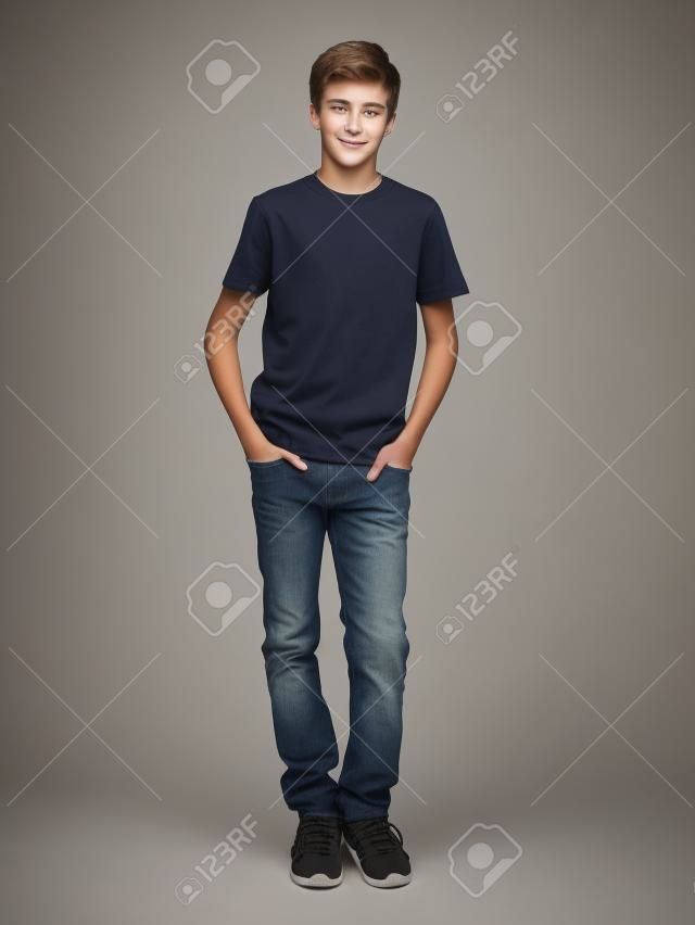 Photo of handsome teenage young guy - looking at camera. Full portrait of pretty boy.