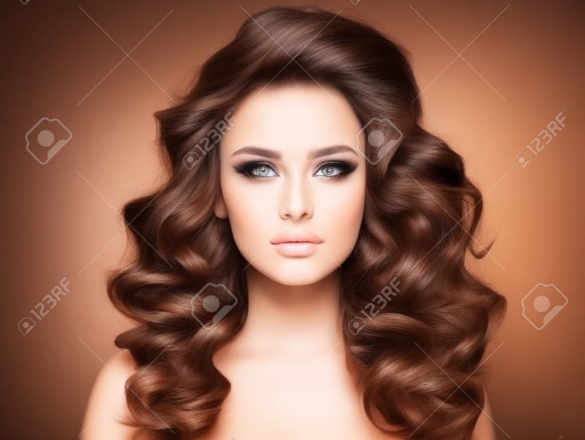 Beautiful woman with brown hair. Beautiful face of an attractive model with beige makeup. Portrait of a beautiful woman with a long hair.  Fashion model. Beautiful stunning girl  with a  curly hairstyle.