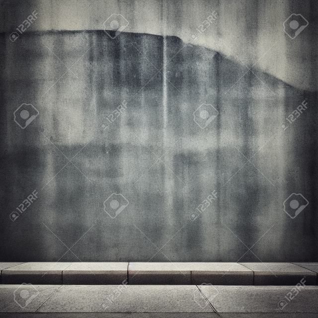 Urban background. Grunge obsolete concrete wall and pavement.