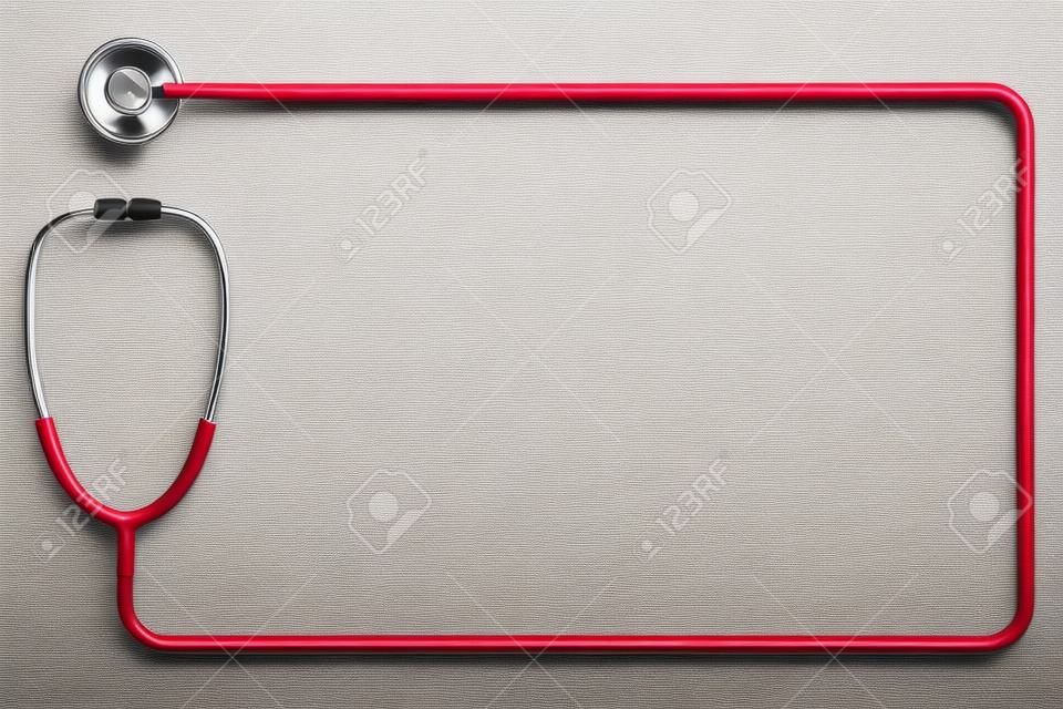 Doctor's stethoscope in red as frame on a white background with space for text