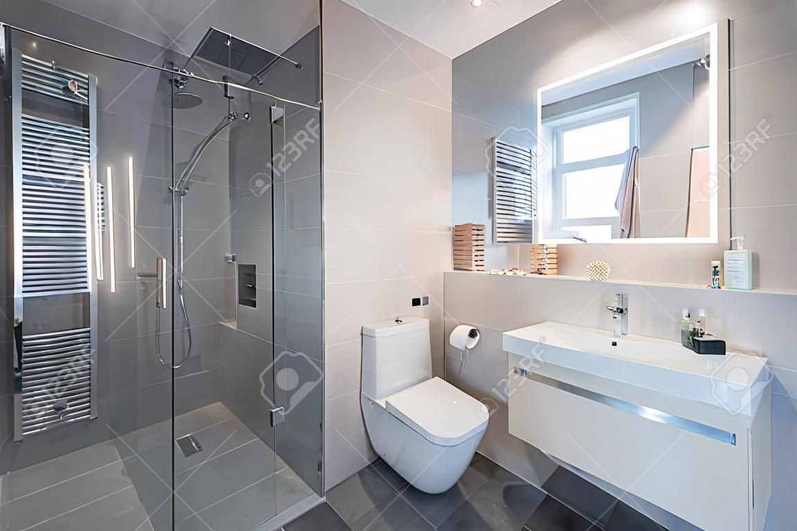 luxury stylish bathroom interior with toilet,bidet sink and spacious glass shower cabin  fancy shower on the wall