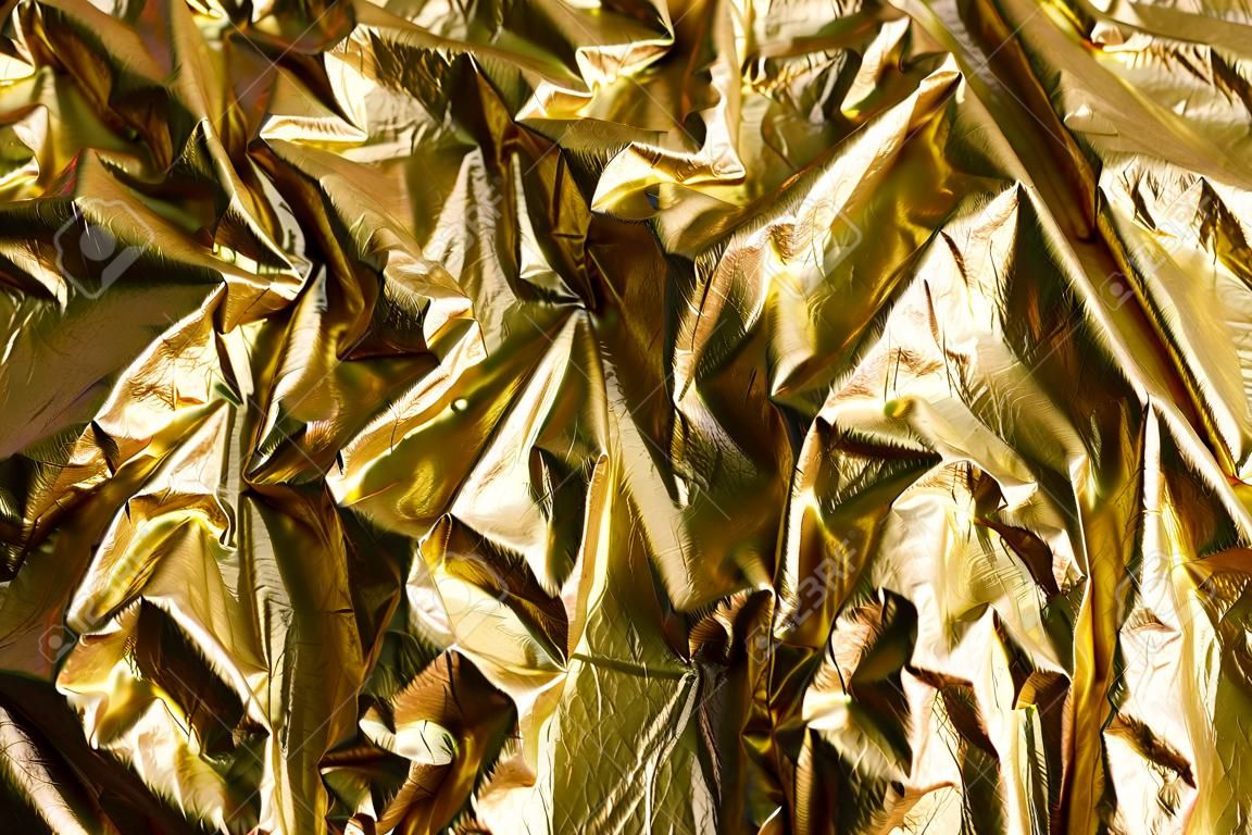 Wrinkled golden foil natural texture background