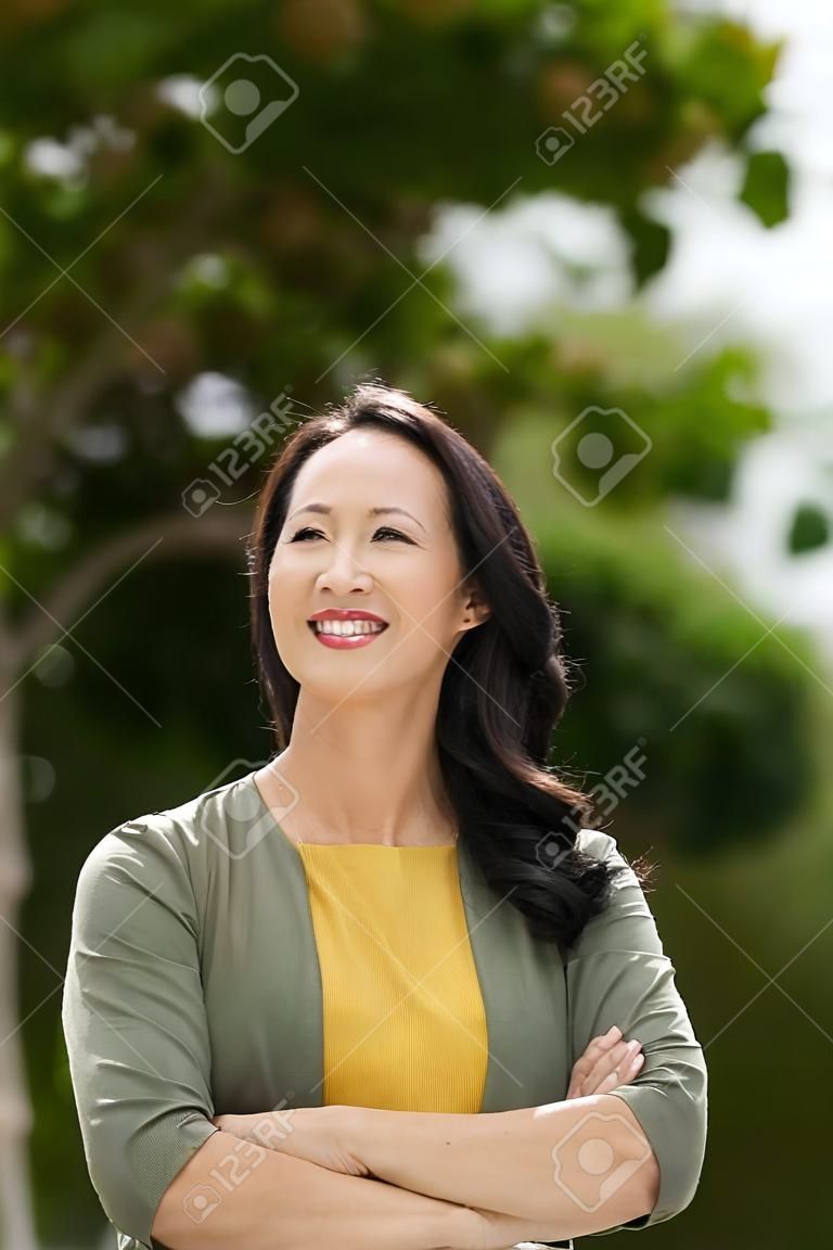 Portrait of beautiful smiling mature woman in the park