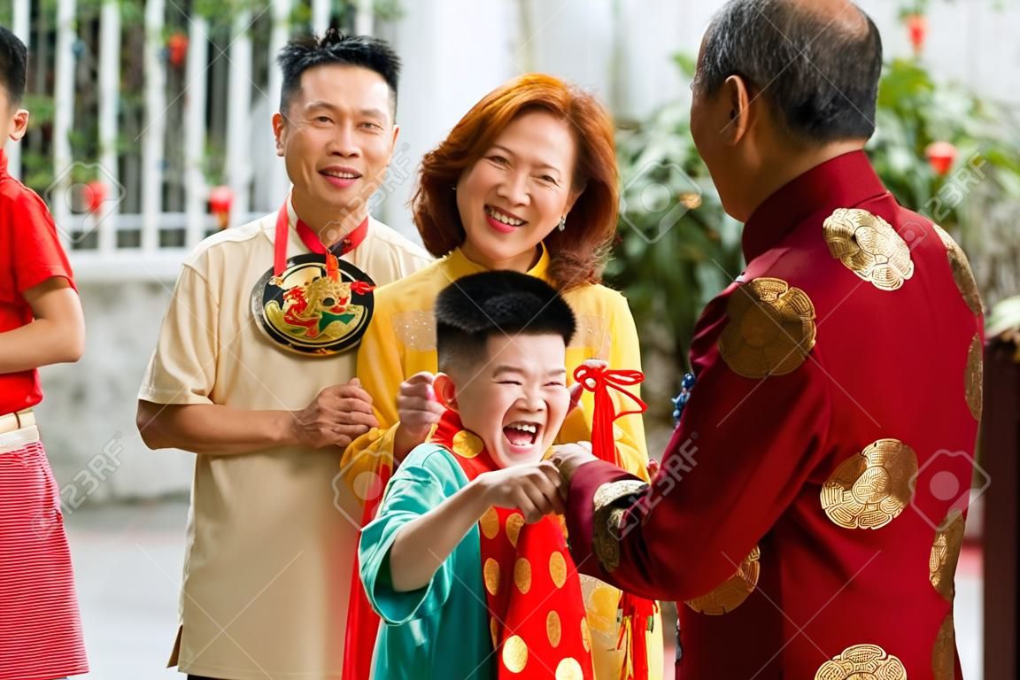 Excited kid happy to visit his grandparents for Chinese New Year family reunion