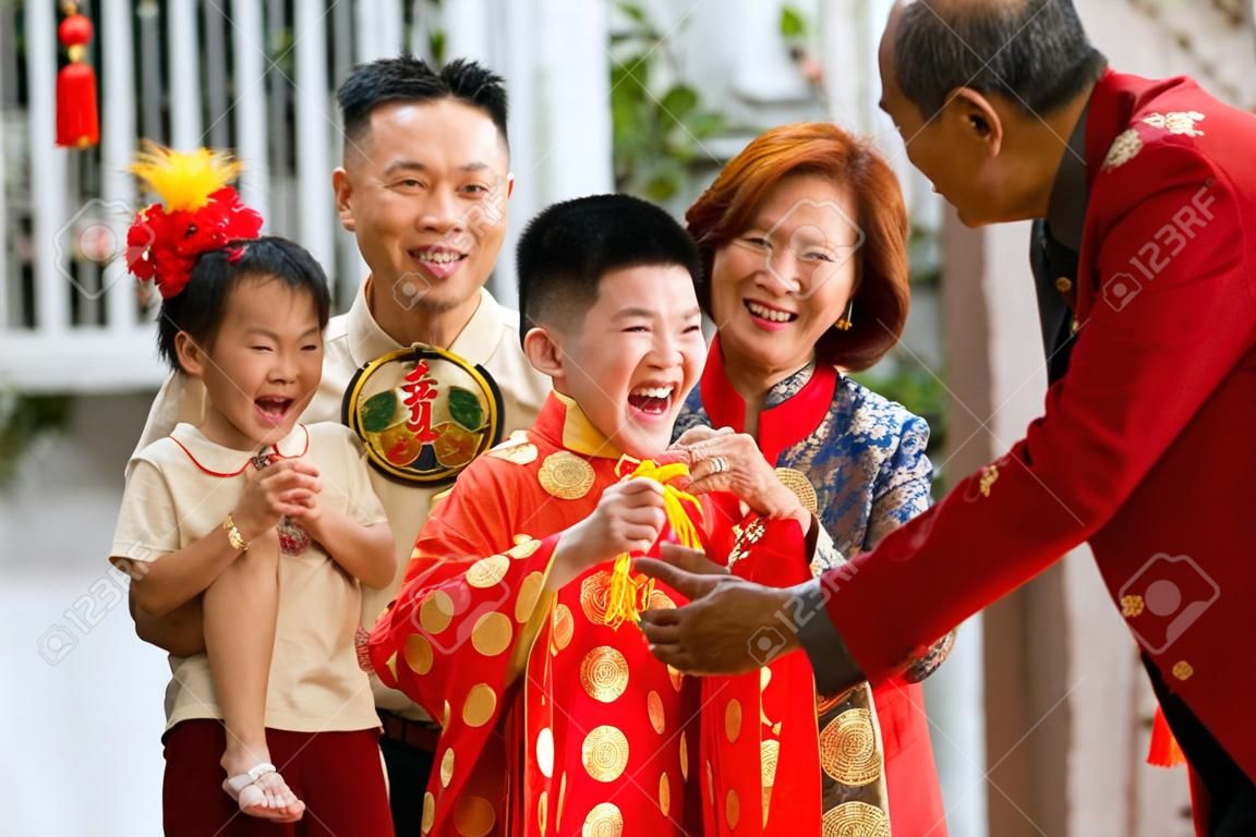 Excited kid happy to visit his grandparents for Chinese New Year family reunion