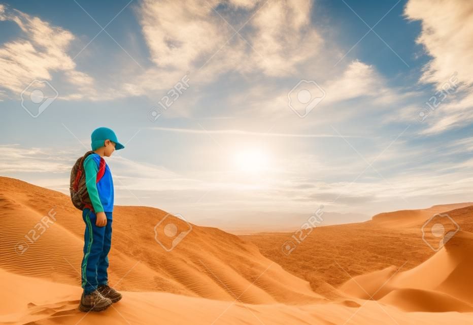 Cute 8 years old boy hiking in  the desert