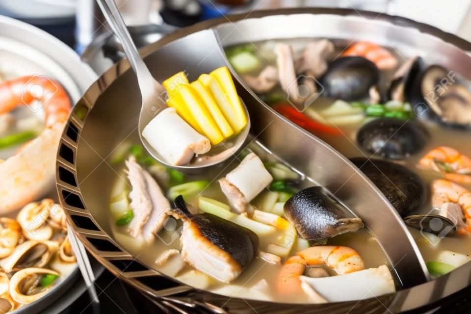 Hot pot of pork, seafood and mushroom in restaurant