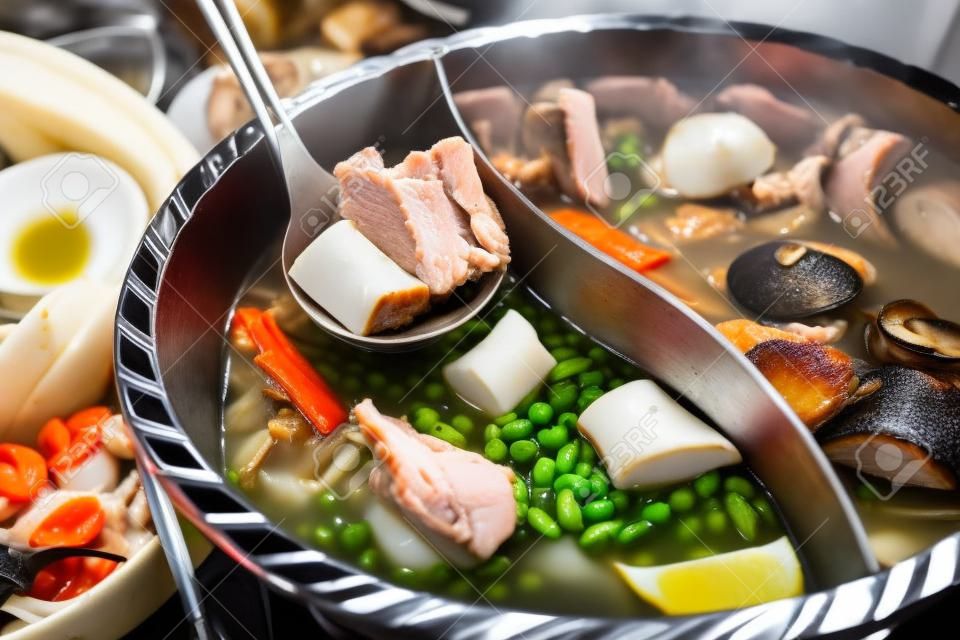 Hot pot of pork, seafood and mushroom in restaurant