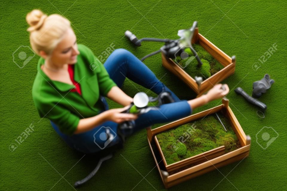 Top view a woman selects stabilized moss for vertical landscaping