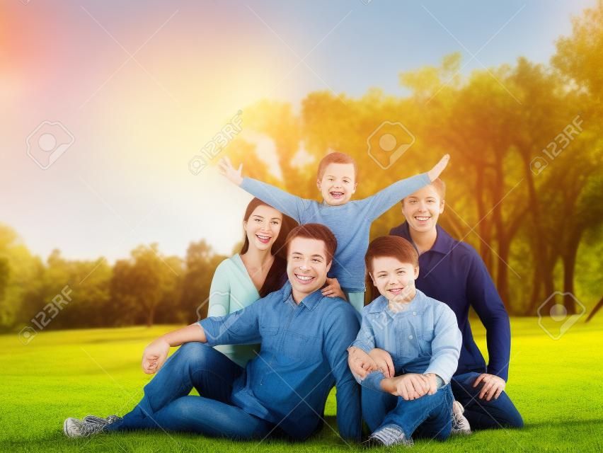 Happy family of five in the park high quality photo